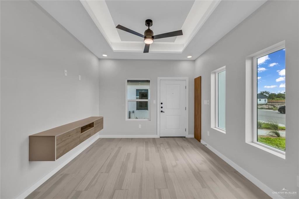 11509 North 25th Street, Unit A McAllen, TX 78504 - Photo 7 of 17 Foyer entrance with light wood-style floors, a raised ceiling, and a ceiling fan
