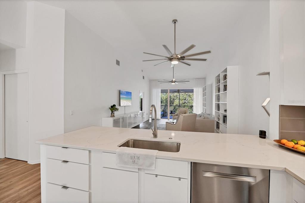 7131 Boca Grove Place, Unit 203 Lakewood Ranch, FL 34202 - Photo 11 of 50 a kitchen with a sink appliances and cabinets