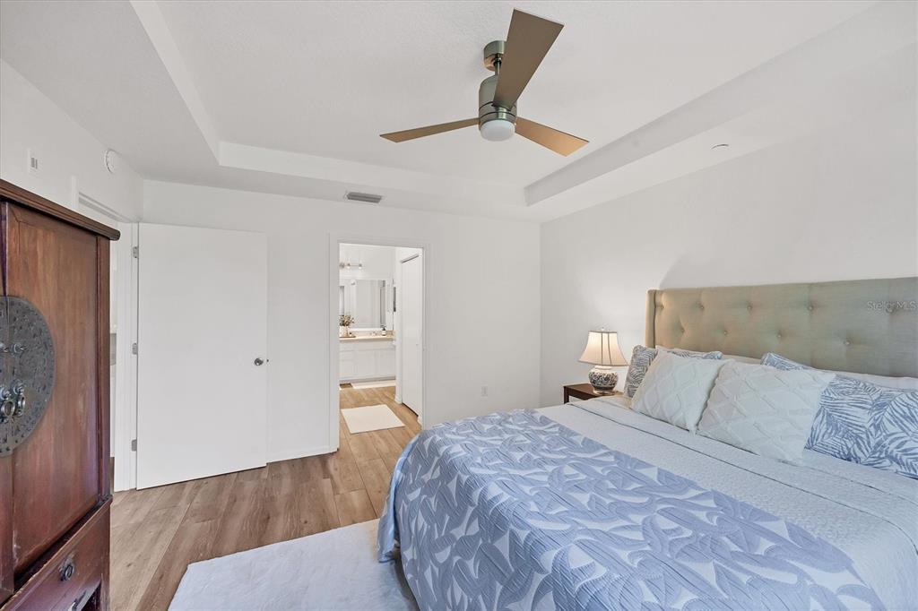 7131 Boca Grove Place, Unit 203 Lakewood Ranch, FL 34202 - Photo 16 of 50 a bedroom with a bed and a ceiling fan