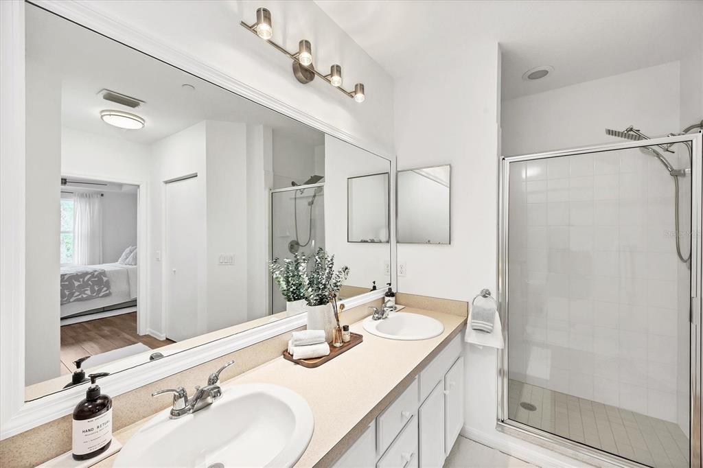 7131 Boca Grove Place, Unit 203 Lakewood Ranch, FL 34202 - Photo 18 of 50 a bathroom with double vanity sinks and a mirror