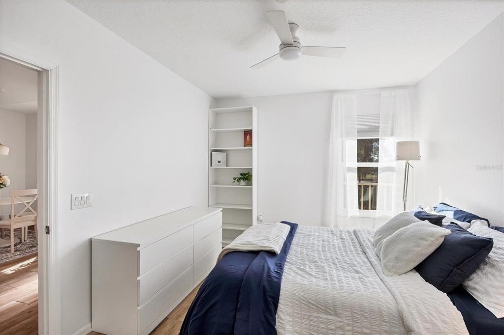 7131 Boca Grove Place, Unit 203 Lakewood Ranch, FL 34202 - Photo 22 of 50 a bedroom with a bed and wooden floor