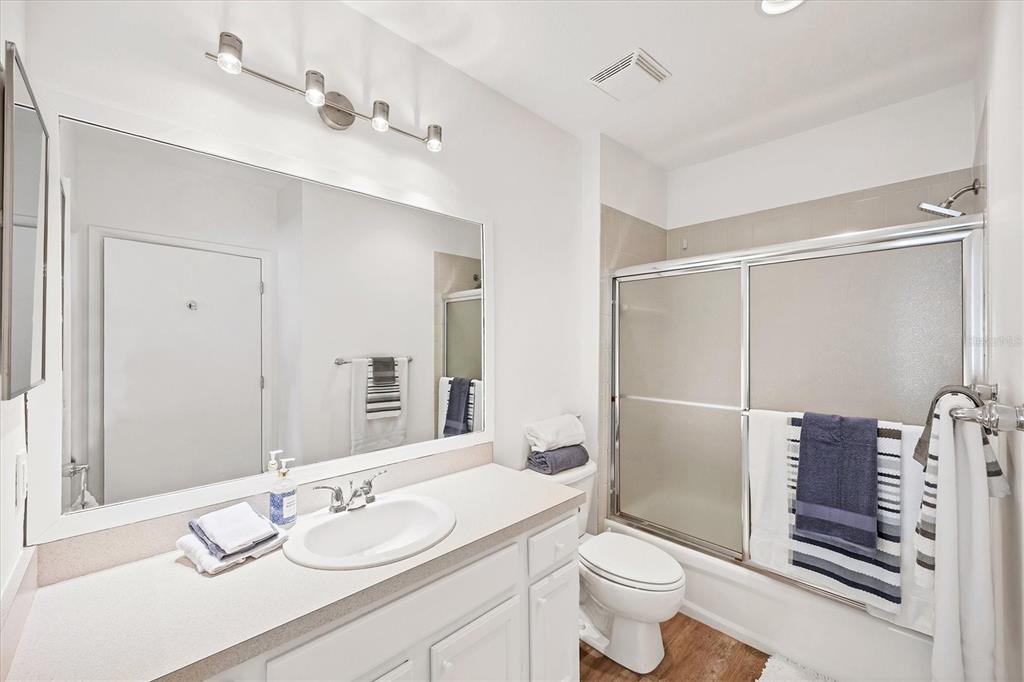7131 Boca Grove Place, Unit 203 Lakewood Ranch, FL 34202 - Photo 23 of 50 a bathroom with a granite countertop sink toilet and shower