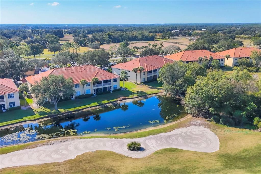 7131 Boca Grove Place, Unit 203 Lakewood Ranch, FL 34202 - Photo 31 of 50 an aerial view of residential houses with outdoor space
