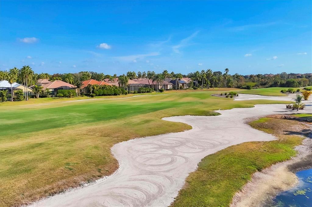 7131 Boca Grove Place, Unit 203 Lakewood Ranch, FL 34202 - Photo 32 of 50 a view of a lake and houses with outdoor space