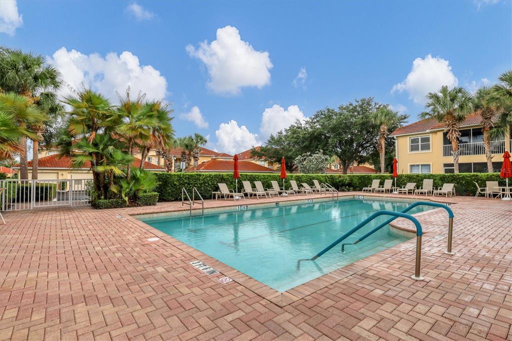 7131 Boca Grove Place, Unit 203 Lakewood Ranch, FL 34202 - Photo 38 of 50 a view of a swimming pool with a patio