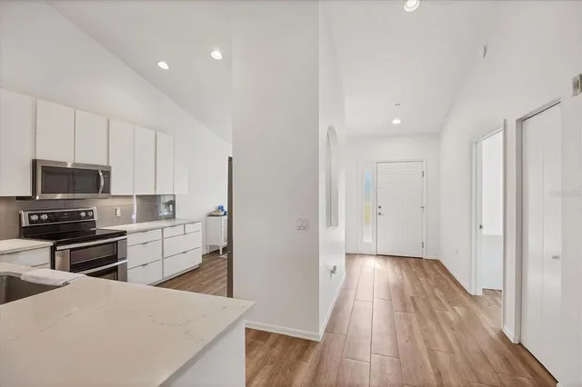 a living room with furniture windows and a wooden floor