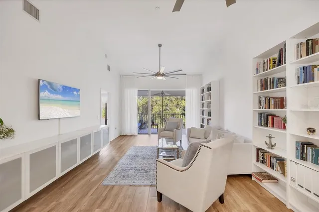 a living room with furniture and a book shelf