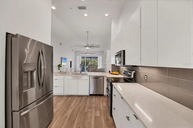 a bedroom with a bed and a ceiling fan