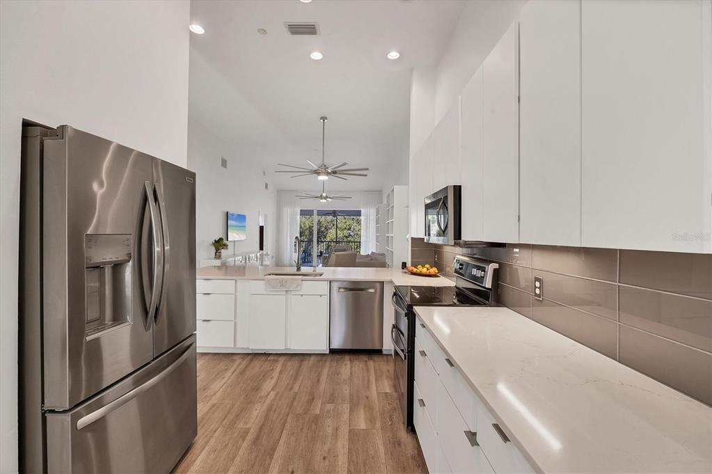 7131 Boca Grove Place, Unit 203 Lakewood Ranch, FL 34202 - Photo 10 of 50 a kitchen with a refrigerator sink and stove