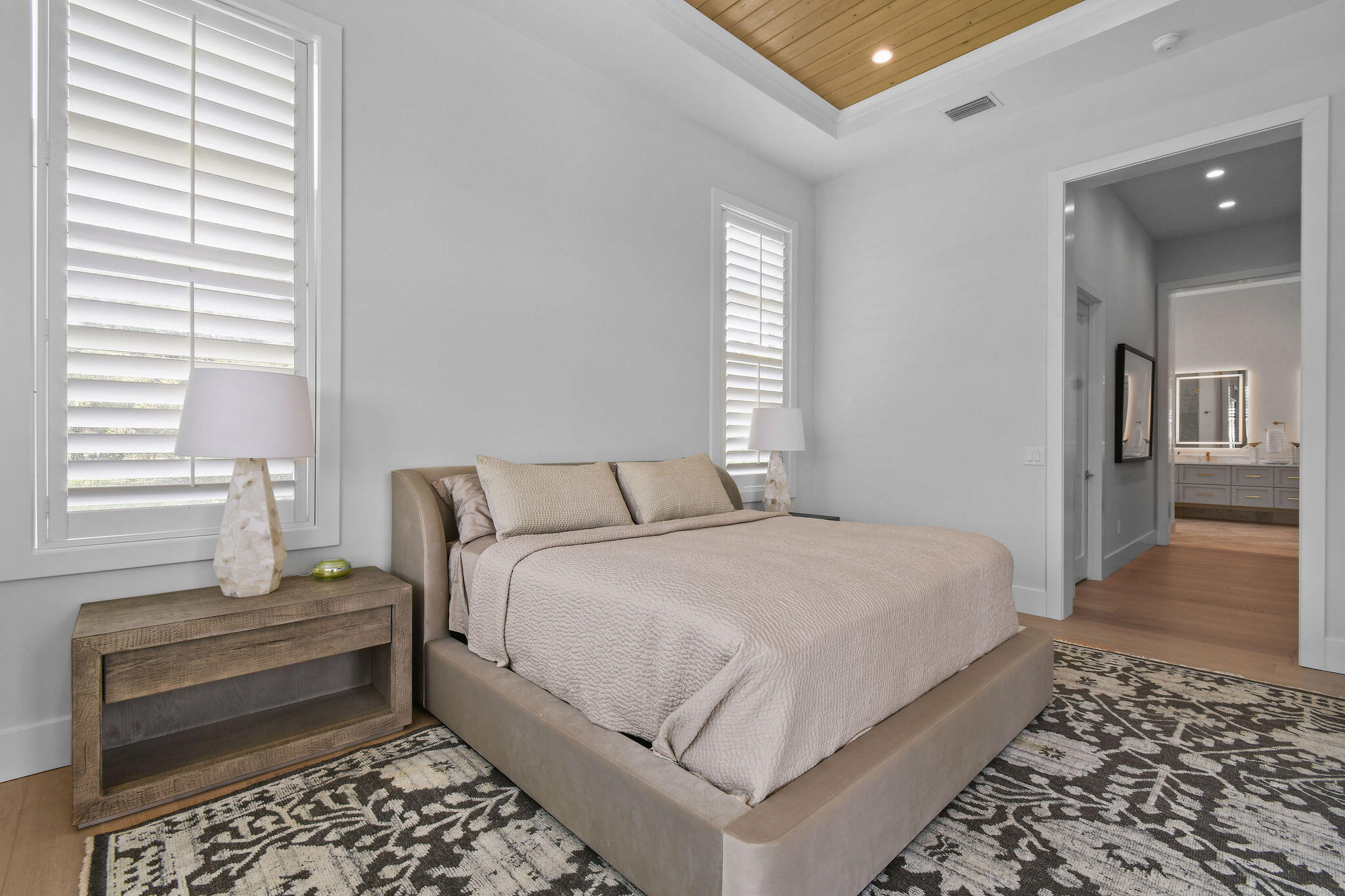 9105 Whippoorwill Trail Jupiter, FL 33478 - Photo 24 of 60 a bedroom with a bed and wooden floor