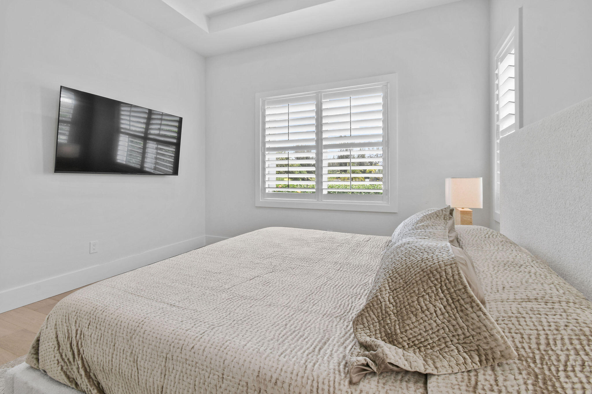 9105 Whippoorwill Trail Jupiter, FL 33478 - Photo 36 of 60 a bedroom with a bed and a flat screen tv