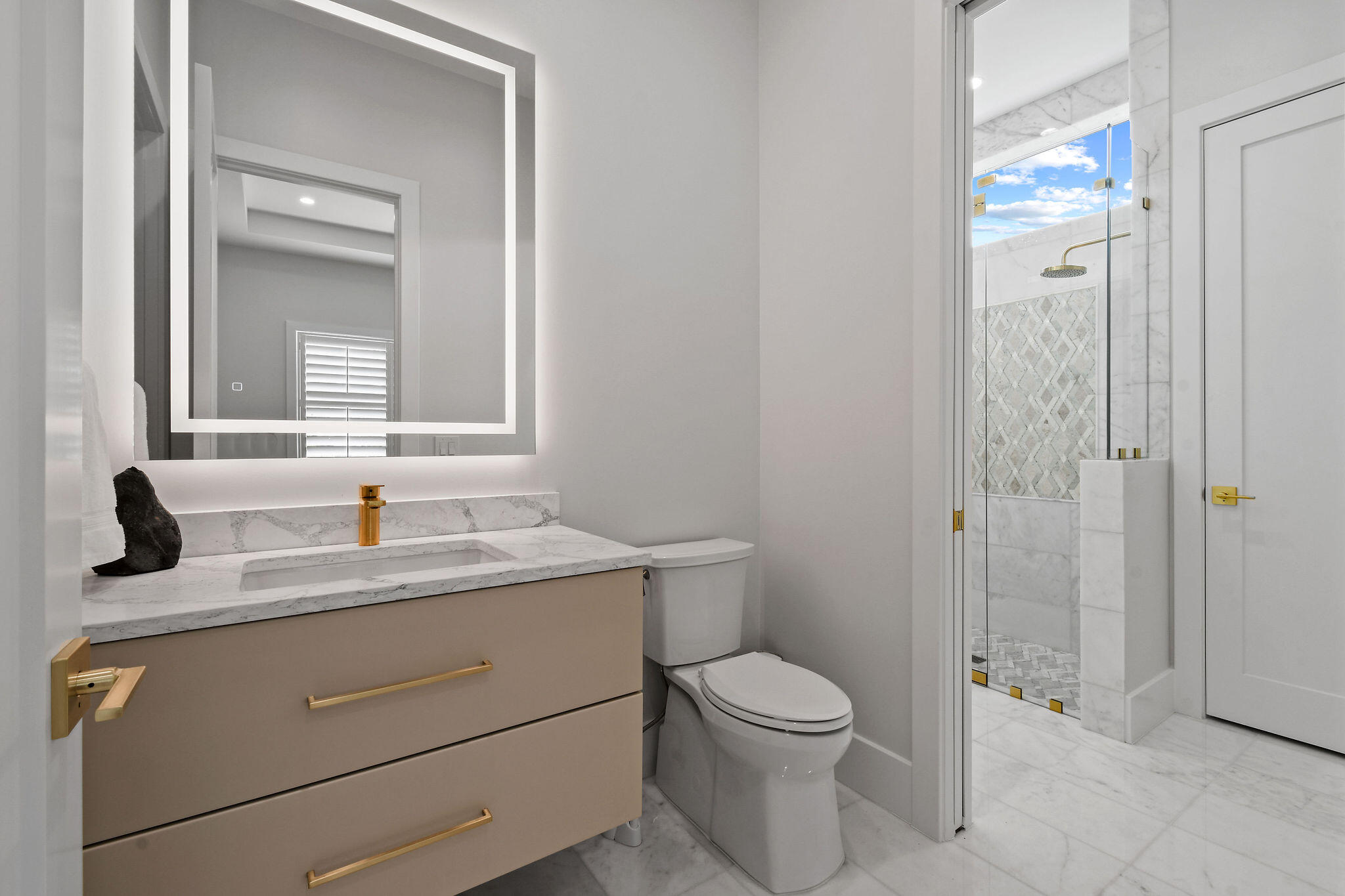 9105 Whippoorwill Trail Jupiter, FL 33478 - Photo 41 of 60 a bathroom with a granite countertop sink toilet and shower