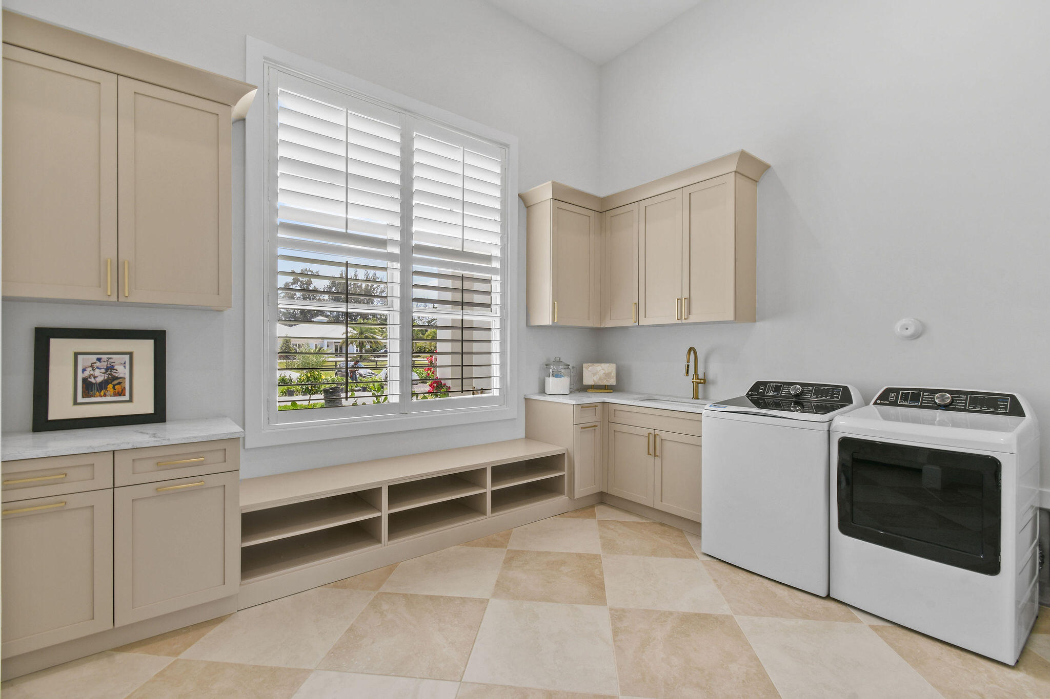9105 Whippoorwill Trail Jupiter, FL 33478 - Photo 47 of 60 a kitchen with a stove and white cabinets