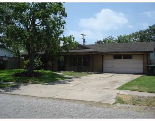 a front view of a house with a yard and a garage