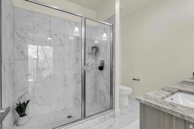 4016 South Burch Way Ogden, UT 84405 - Photo 13 of 30 Glass-enclosed shower with white marble-style tile surround and floor, accented by two pendant light fixtures