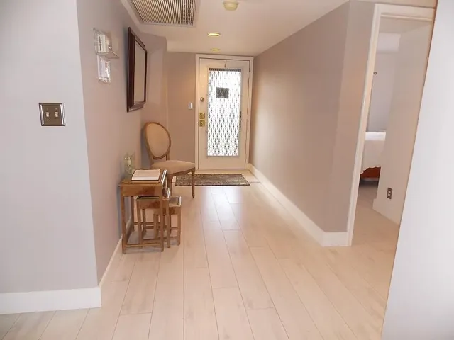 a view of a room with furniture and wooden floor