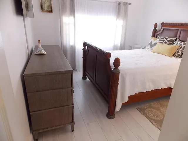 a bedroom with a bed and a dresser