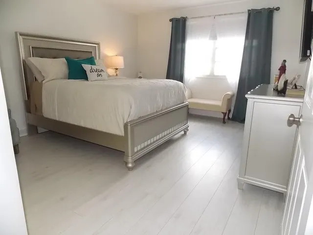 a bedroom with a bed and a window