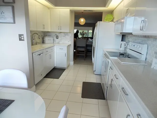 a kitchen with a sink a stove and refrigerator