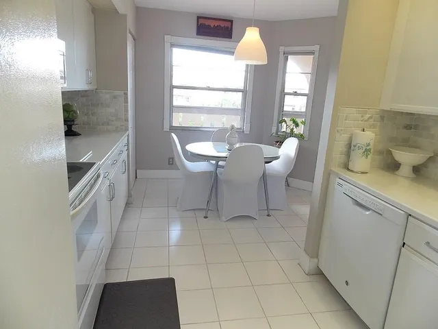 a view of a kitchen area with furniture and windows