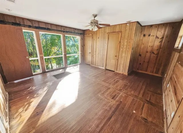 a view of a room with wooden floor and doors