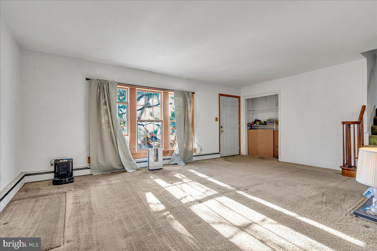 995 Smithbridge Road Glen Mills, PA 19342 - Photo 4 of 20 a view of a livingroom with a staircase and a flat screen tv