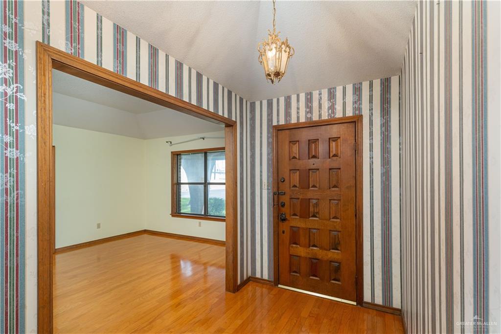 1100 Xanthisma Avenue McAllen, TX 78504 - Photo 2 of 26 wooden floor in an empty room with a window