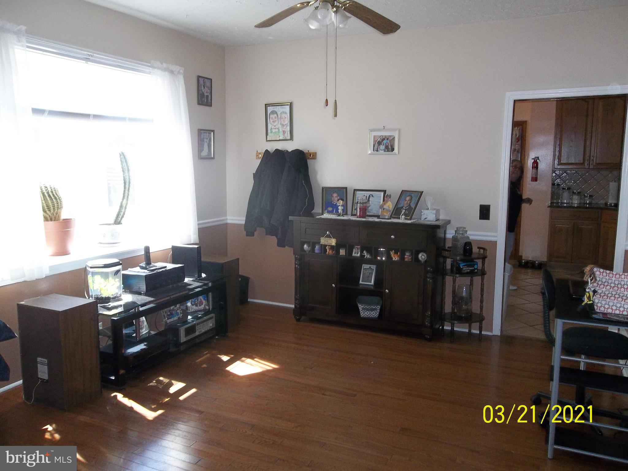 128 Madison Street Riverside, NJ 08075 - Photo 13 of 40 a living room with furniture and a floor to ceiling window