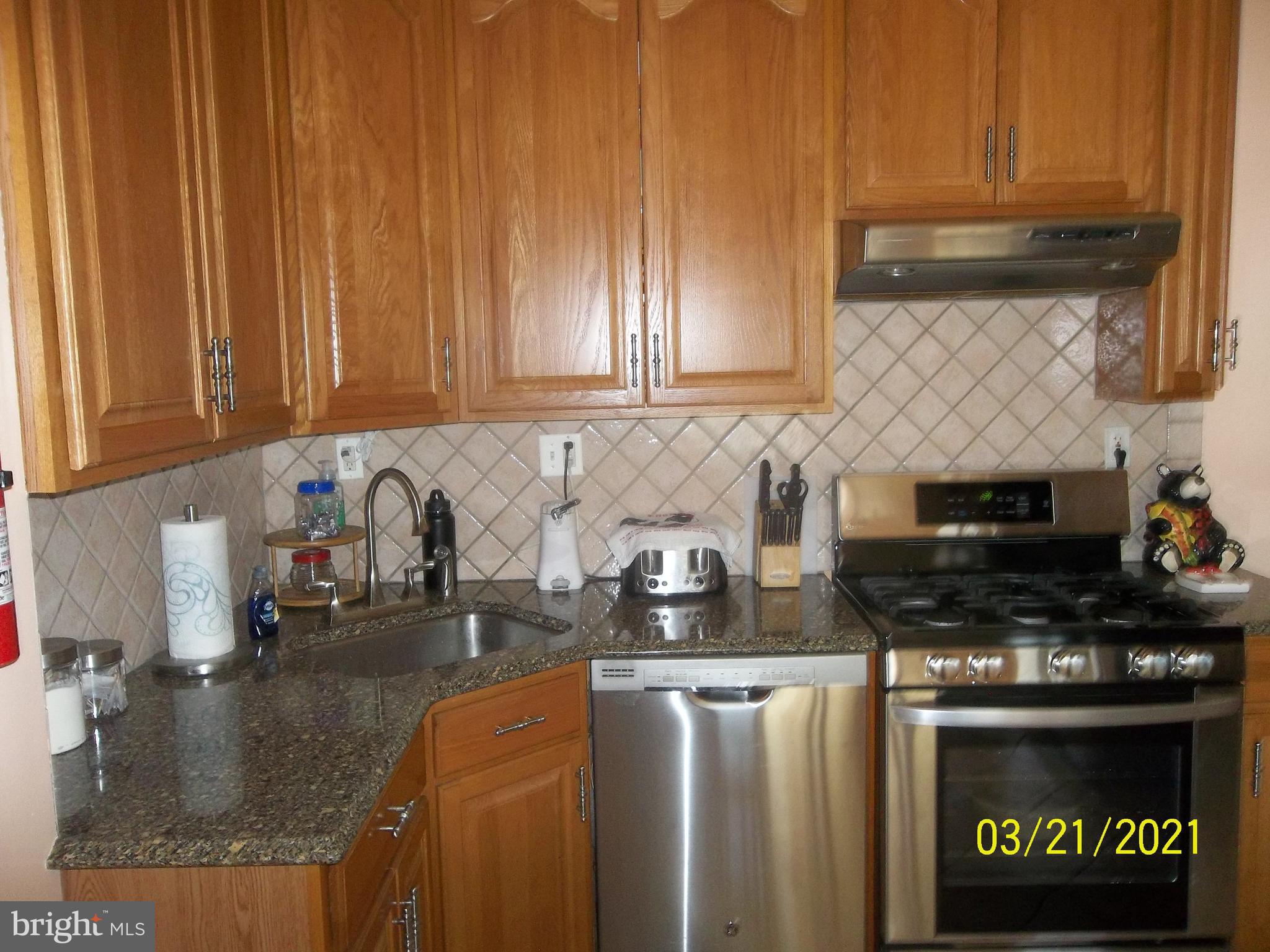 128 Madison Street Riverside, NJ 08075 - Photo 15 of 40 a kitchen with stainless steel appliances granite countertop a sink a stove and a cabinets
