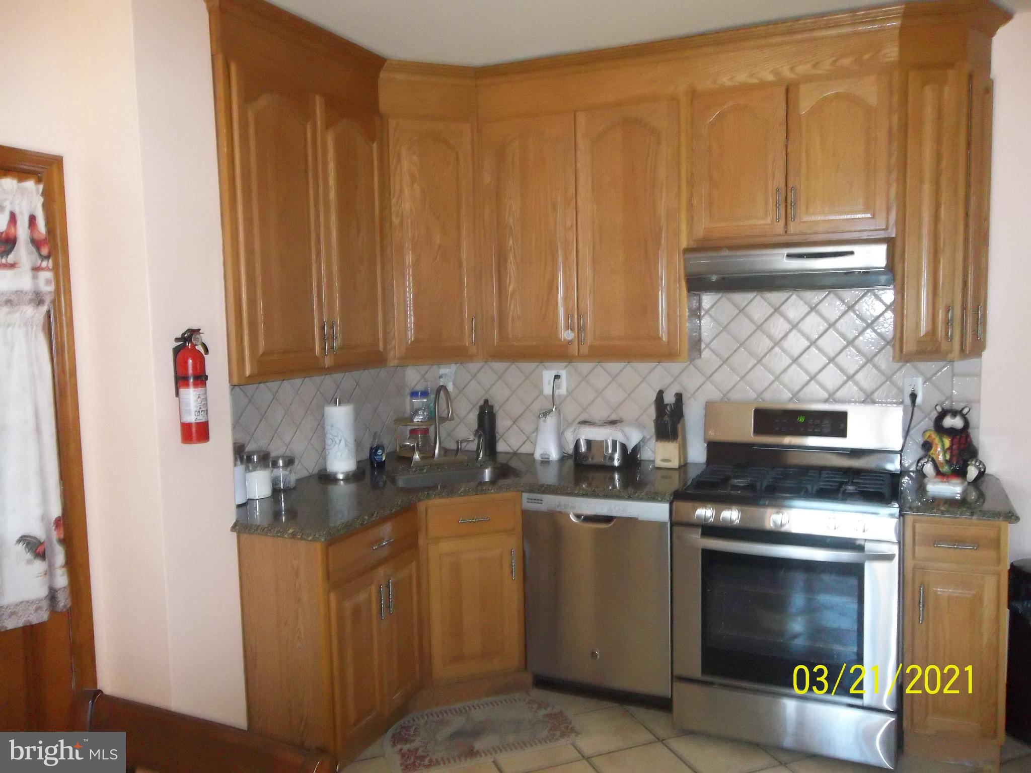 128 Madison Street Riverside, NJ 08075 - Photo 16 of 40 a kitchen with stainless steel appliances a stove a sink and a microwave