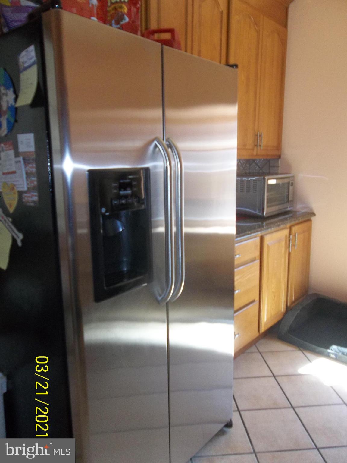 128 Madison Street Riverside, NJ 08075 - Photo 18 of 40 a kitchen with granite countertop stainless steel appliances and a refrigerator