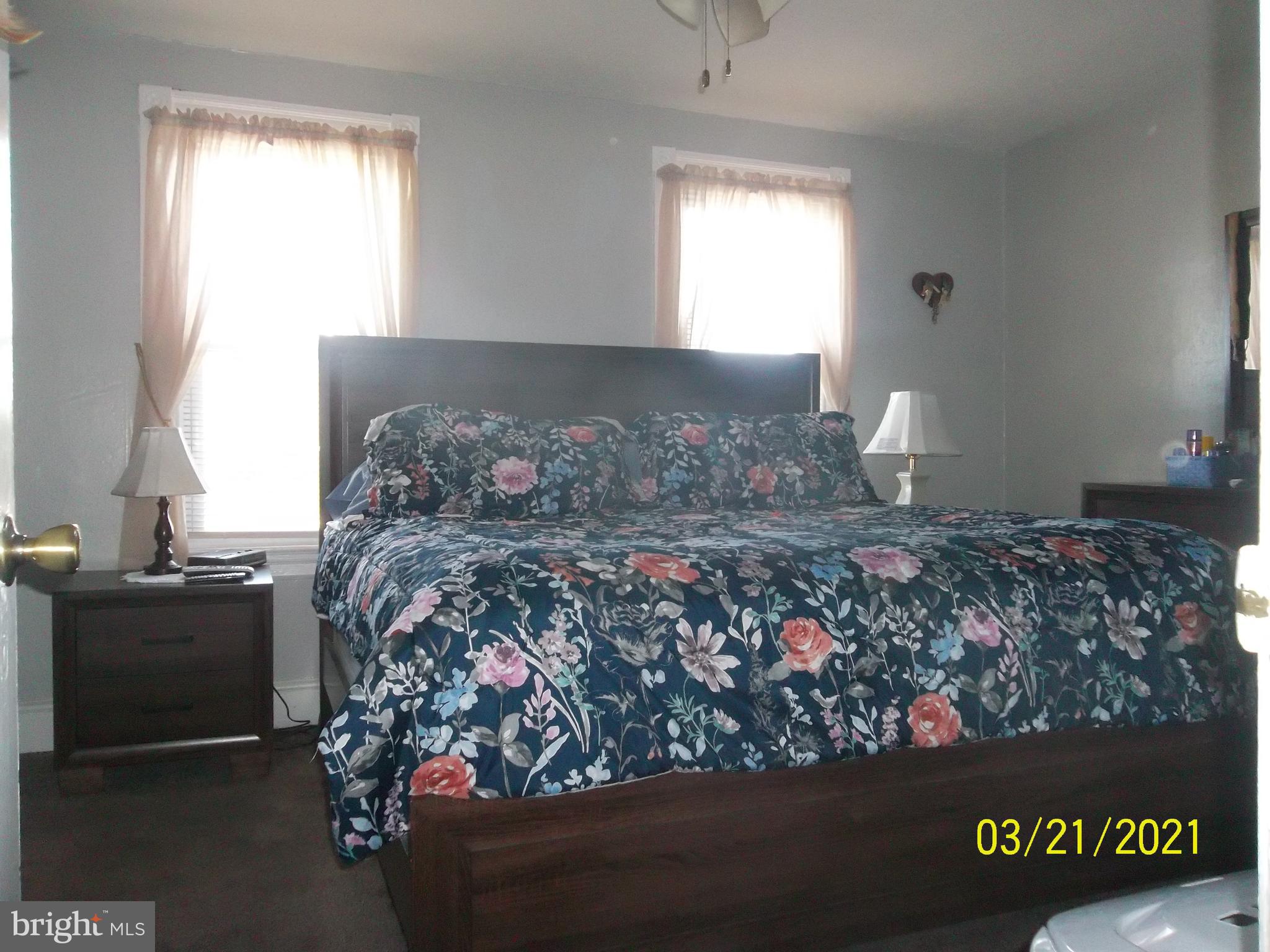 128 Madison Street Riverside, NJ 08075 - Photo 29 of 40 a bed sitting in a bedroom next to a window
