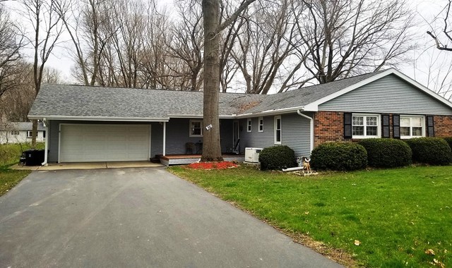 16210 Strawberry Road Morrison, IL 61270 - Photo 1 of 17 a front view of a house with a yard and garage