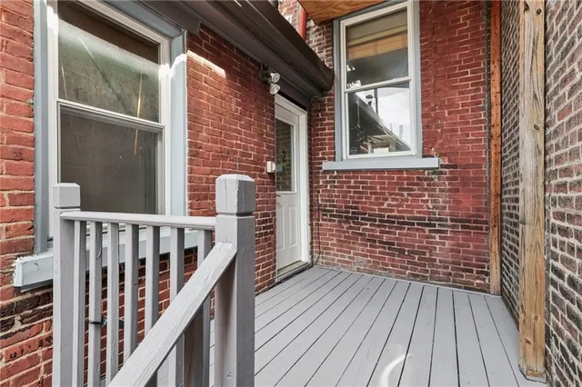 a view of wooden balcony with two chairs