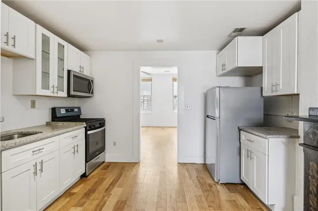 a kitchen with stainless steel appliances a refrigerator stove microwave and sink