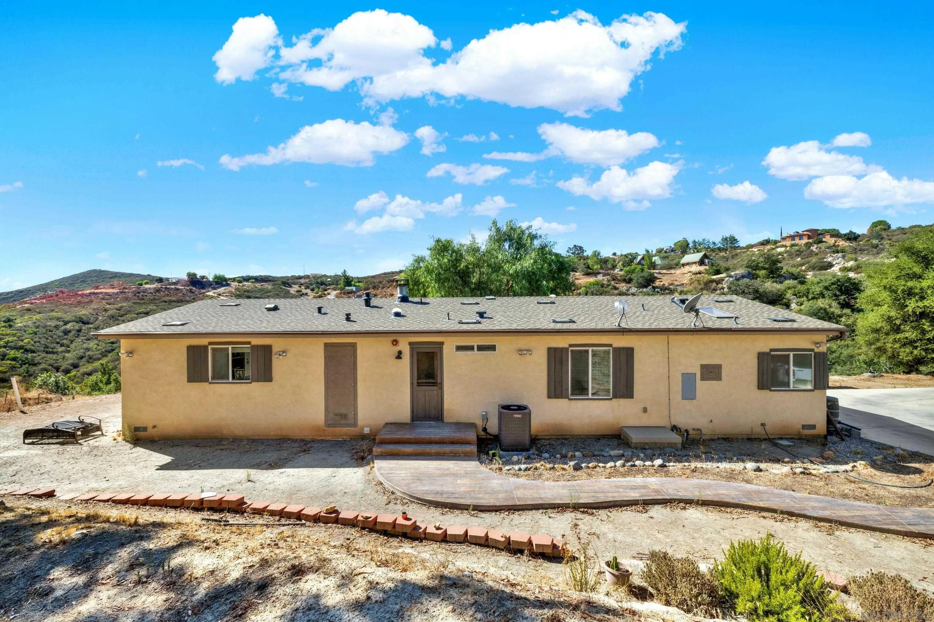 20885 Daum Road Jamul, CA 91935 - Photo 1 of 36 a view of a white house with a yard