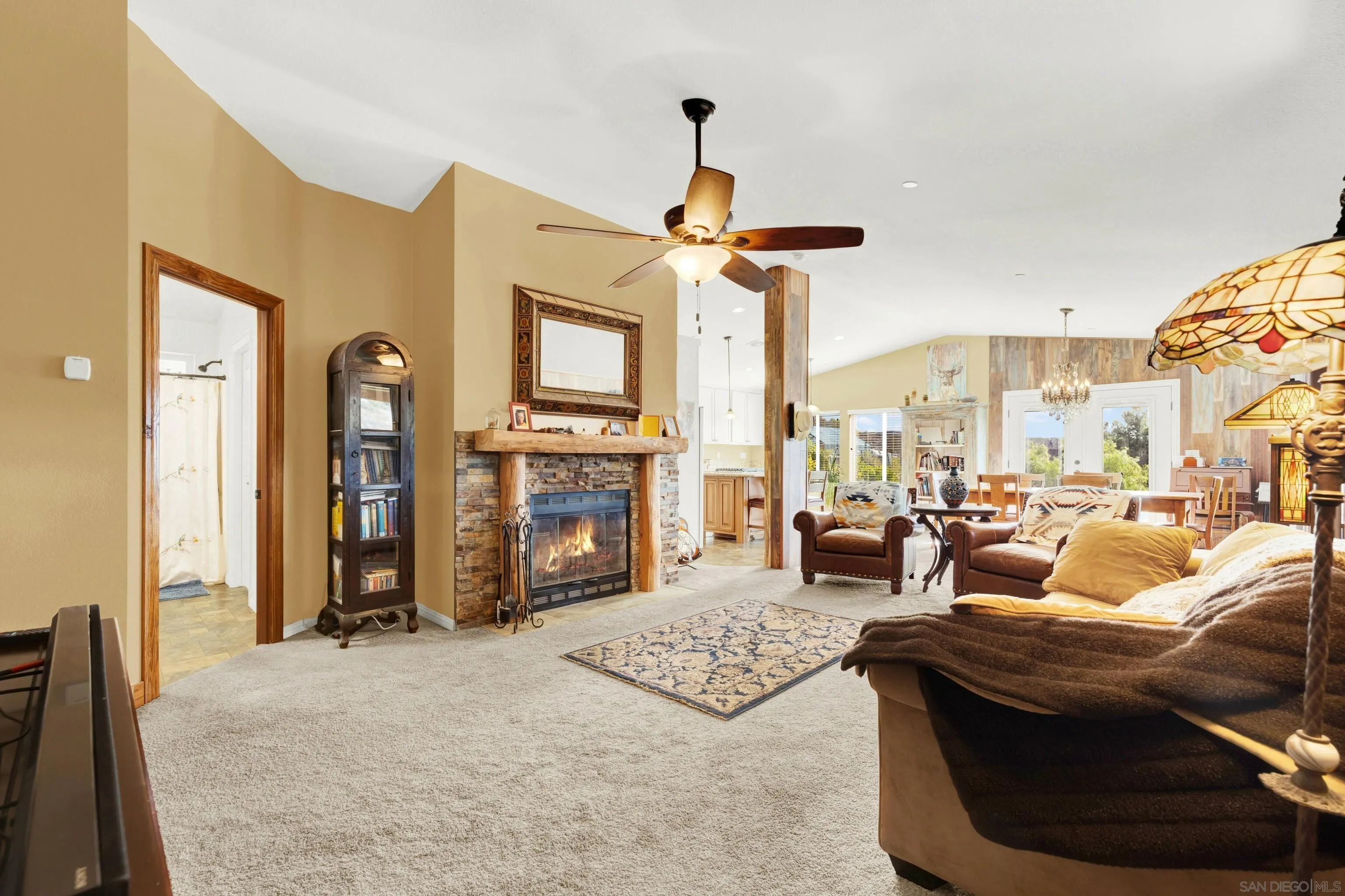 20885 Daum Road Jamul, CA 91935 - Photo 13 of 36 a living room with furniture a fireplace and a chandelier