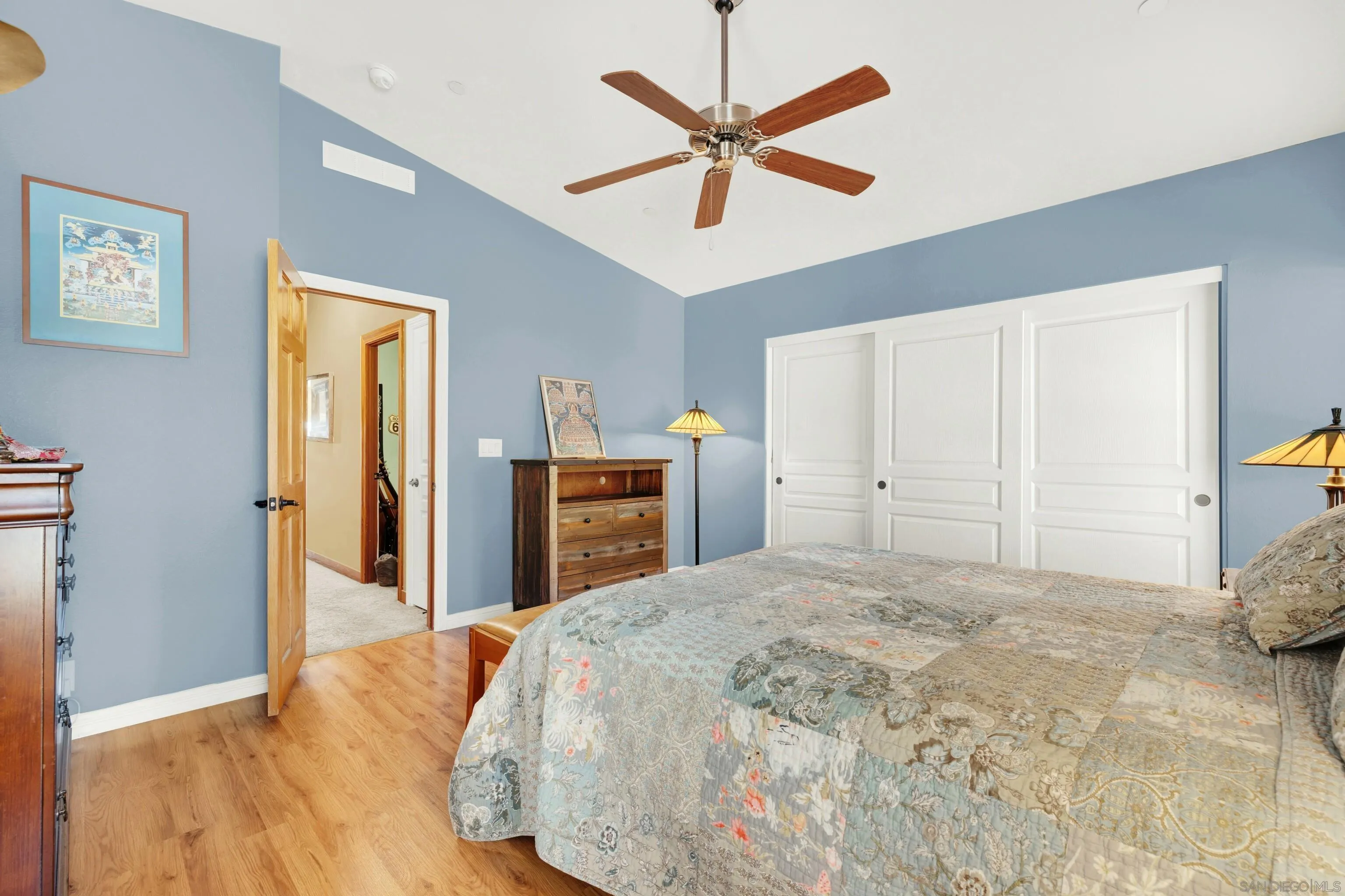20885 Daum Road Jamul, CA 91935 - Photo 21 of 36 a bedroom with a large bed and a chandelier