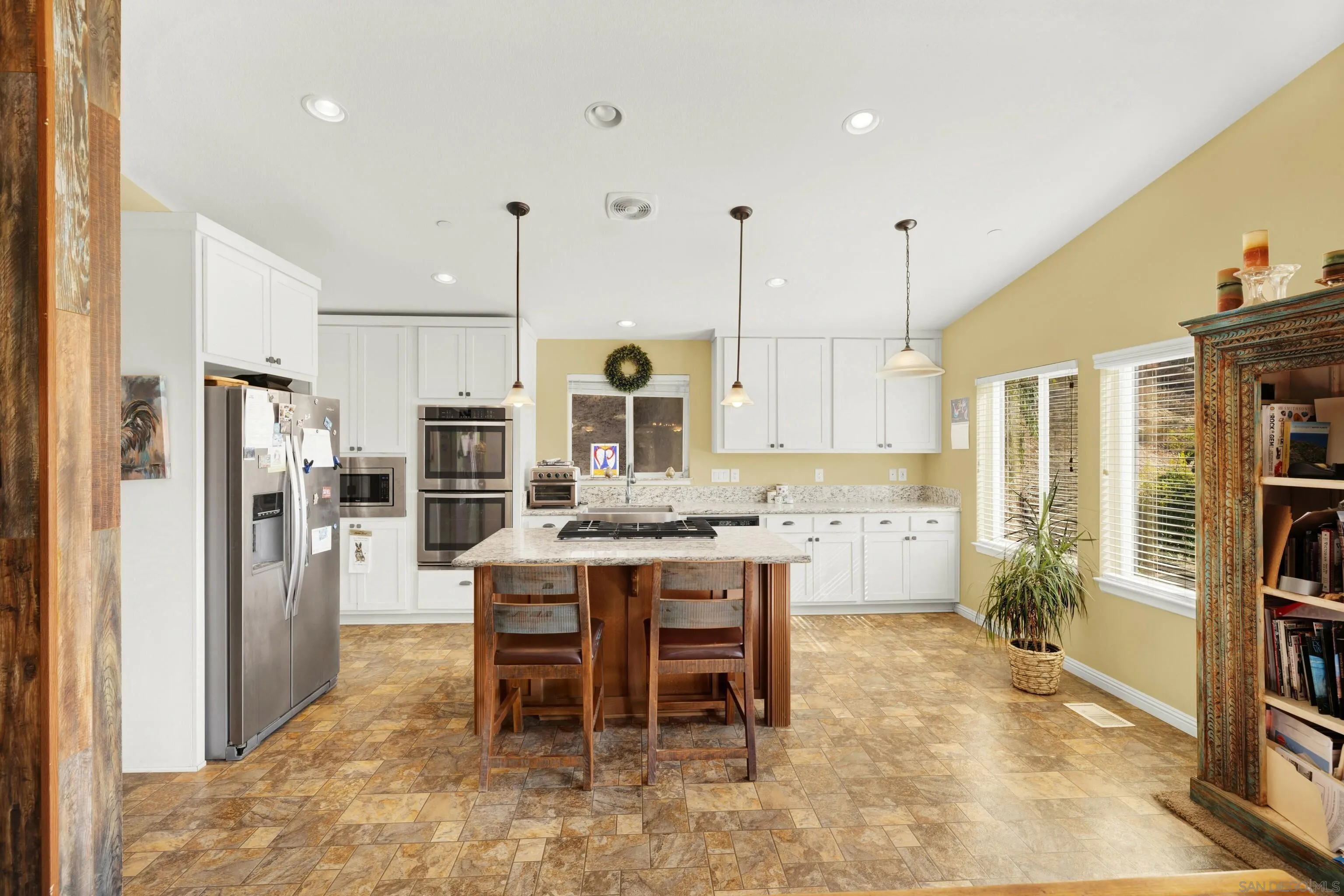 20885 Daum Road Jamul, CA 91935 - Photo 7 of 36 a room with stainless steel appliances kitchen island granite countertop furniture and a view of living room