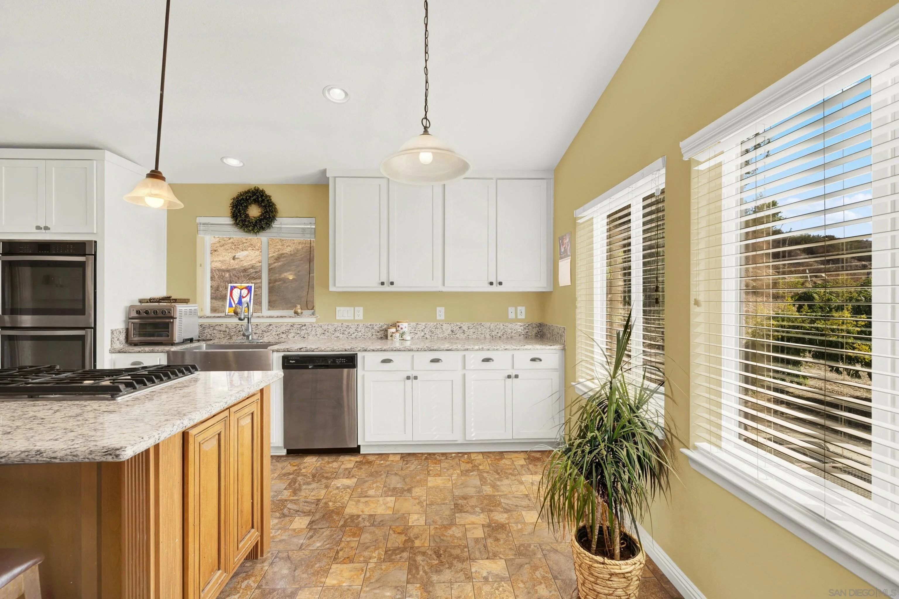 20885 Daum Road Jamul, CA 91935 - Photo 8 of 36 a kitchen with a sink stove and cabinets