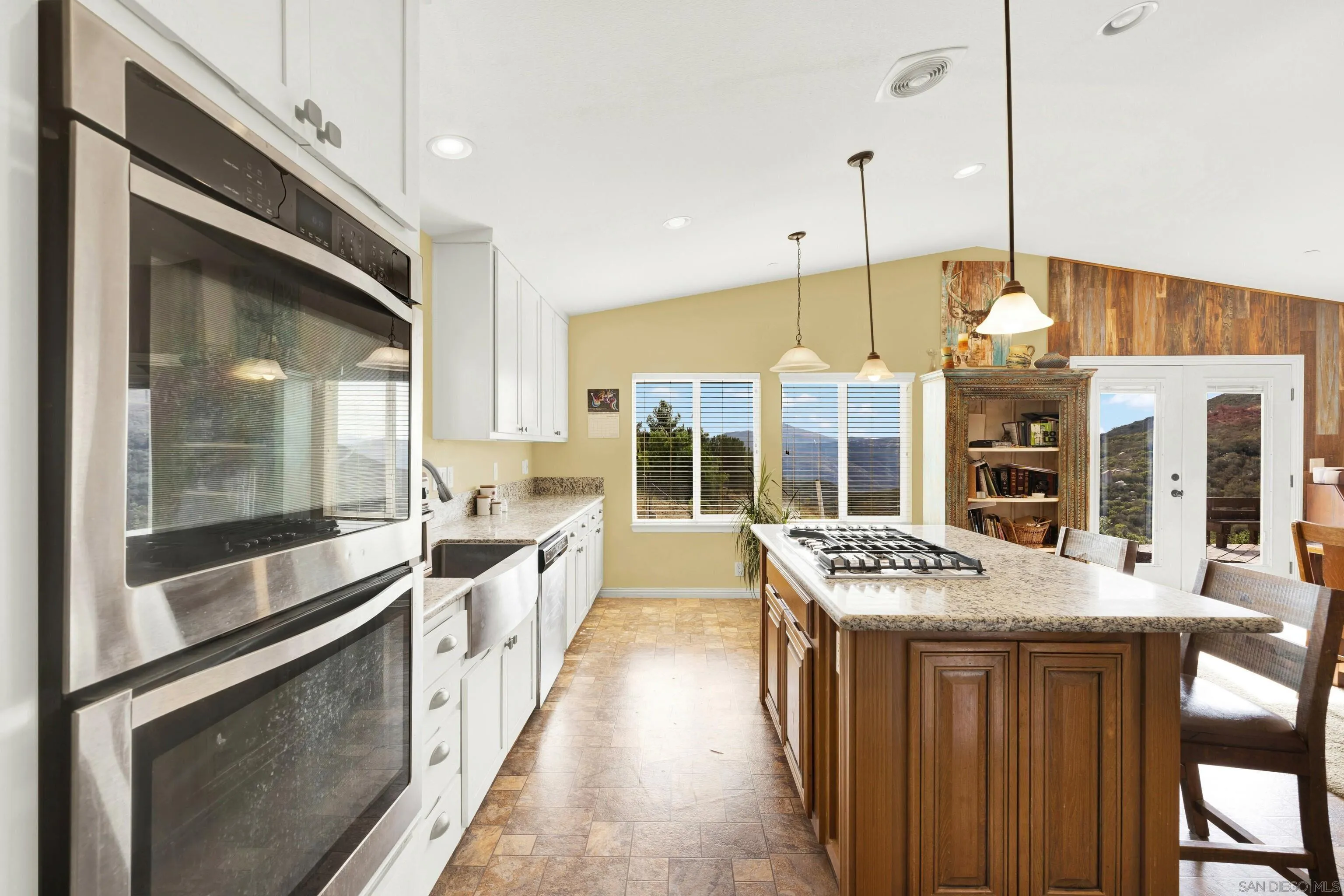 20885 Daum Road Jamul, CA 91935 - Photo 9 of 36 a large kitchen with granite countertop a stove and a sink