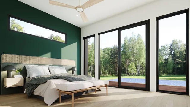 a bedroom with furniture and large windows