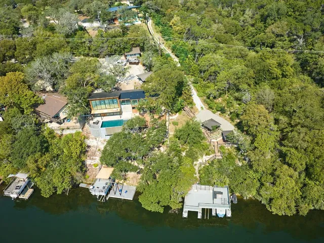 an aerial view of a house with a yard