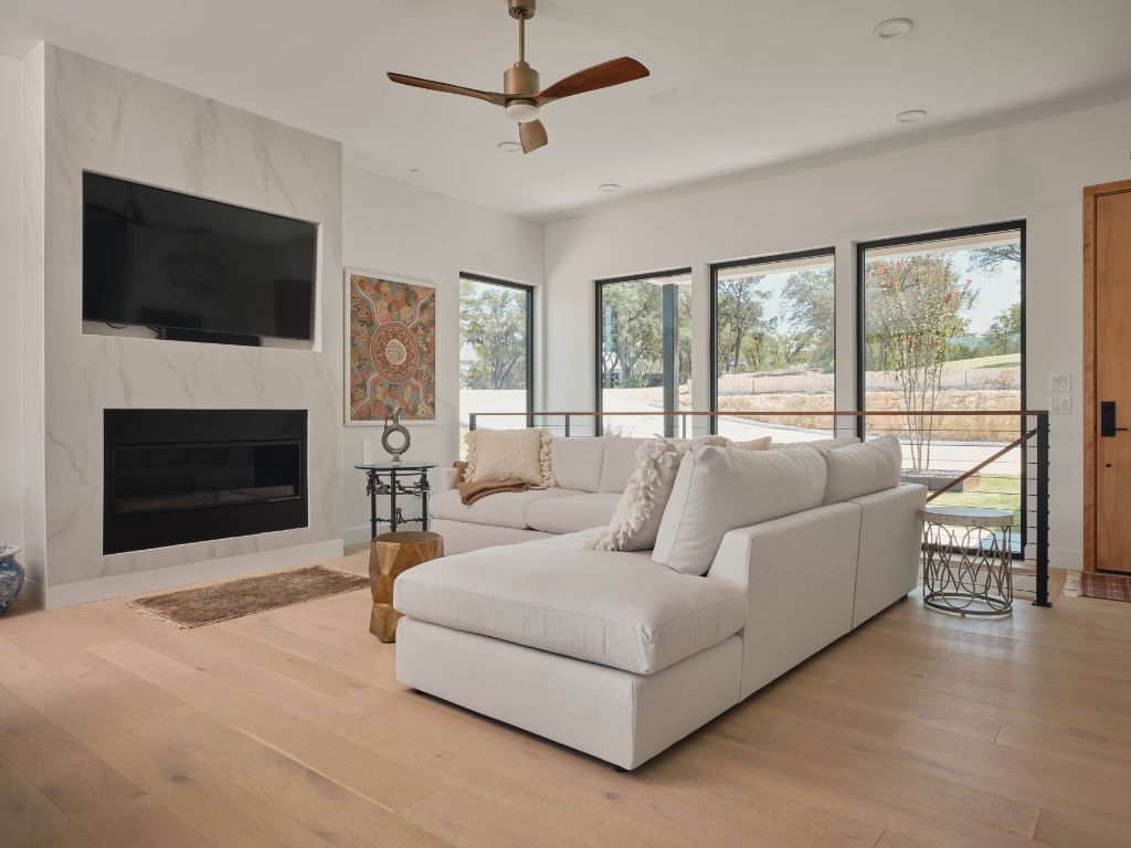 3214 Smoky Ridge Austin, TX 78730 - Photo 6 of 40 a living room with furniture a flat screen tv and a fireplace