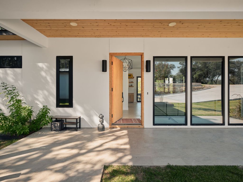 3214 Smoky Ridge Austin, TX 78730 - Photo 9 of 40 a view of a patio with potted plants and floor to ceiling window