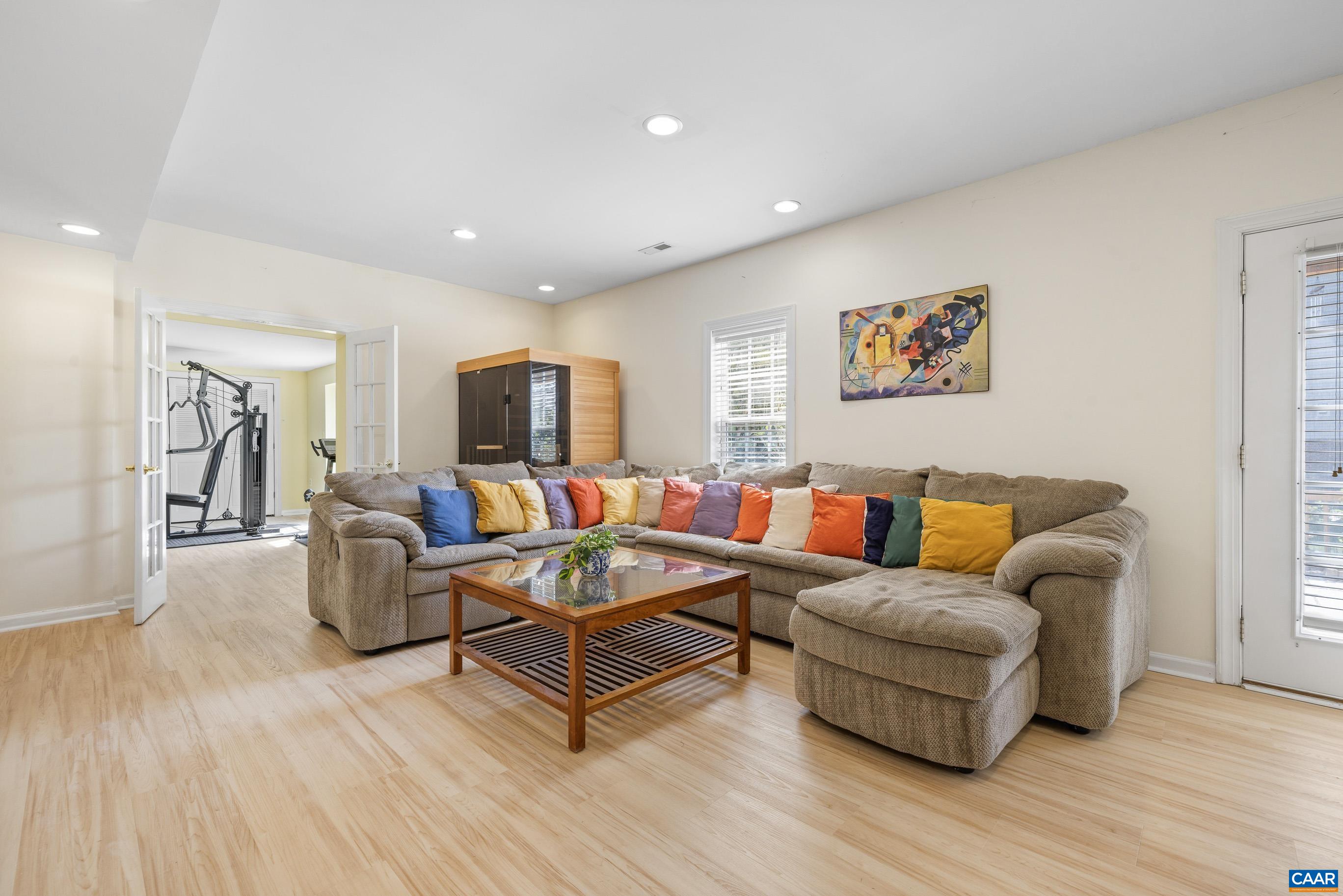 1236 Amber Ridge Road Charlottesville, VA 22901 - Photo 42 of 56 a living room with furniture and a flat screen tv