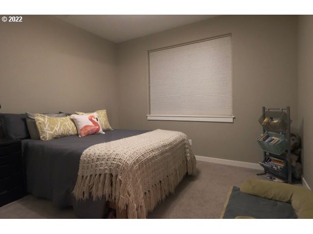 598 Oak Valley Loop Winchester, OR 97495 - Photo 13 of 21 a bedroom with a bed and wooden floor