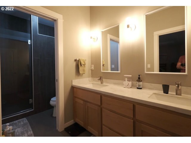 598 Oak Valley Loop Winchester, OR 97495 - Photo 16 of 21 a bathroom with a double vanity sink and mirror