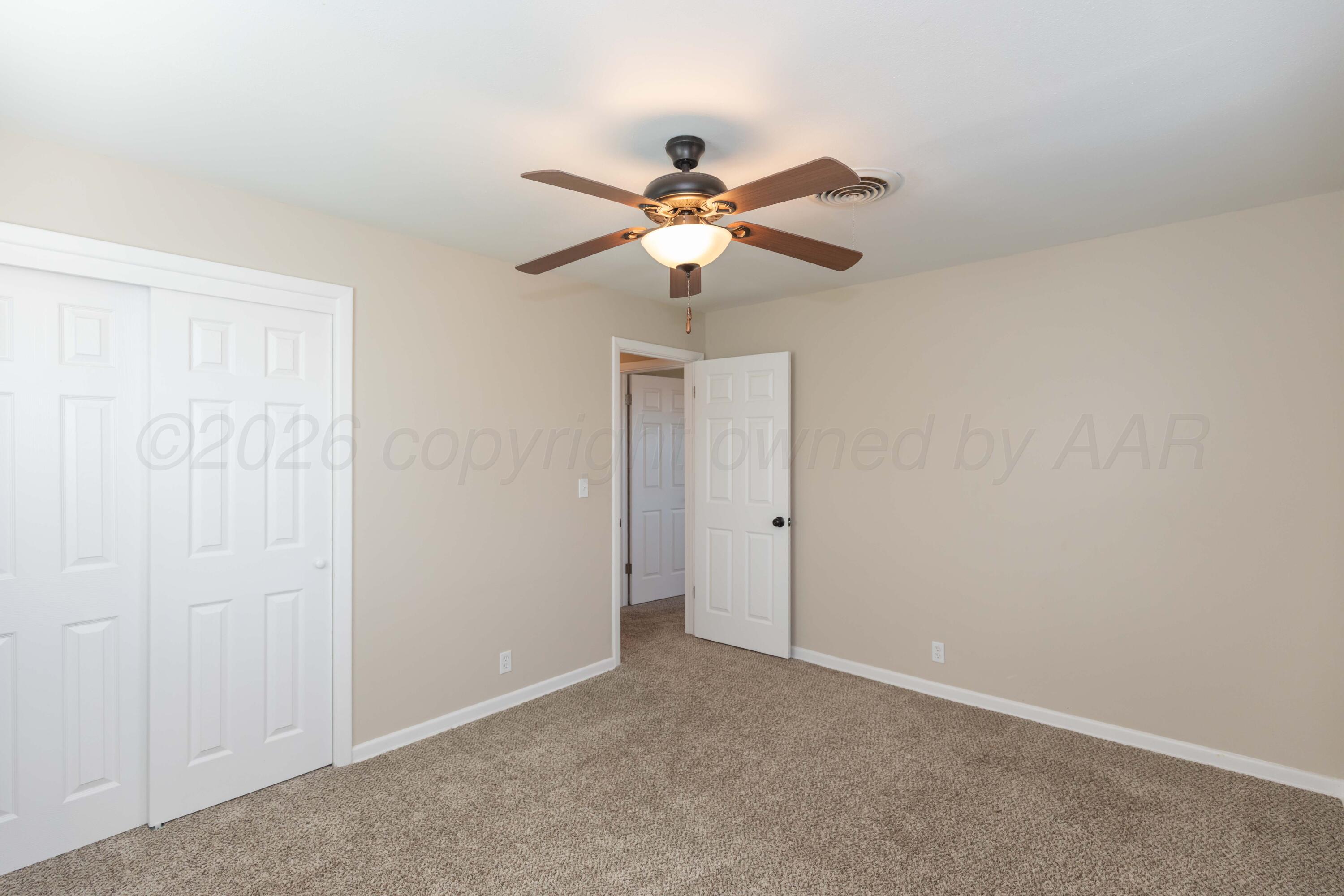 105 Smith Street Borger, TX 79007 - Photo 13 of 26 a view of a chandelier fan in a room