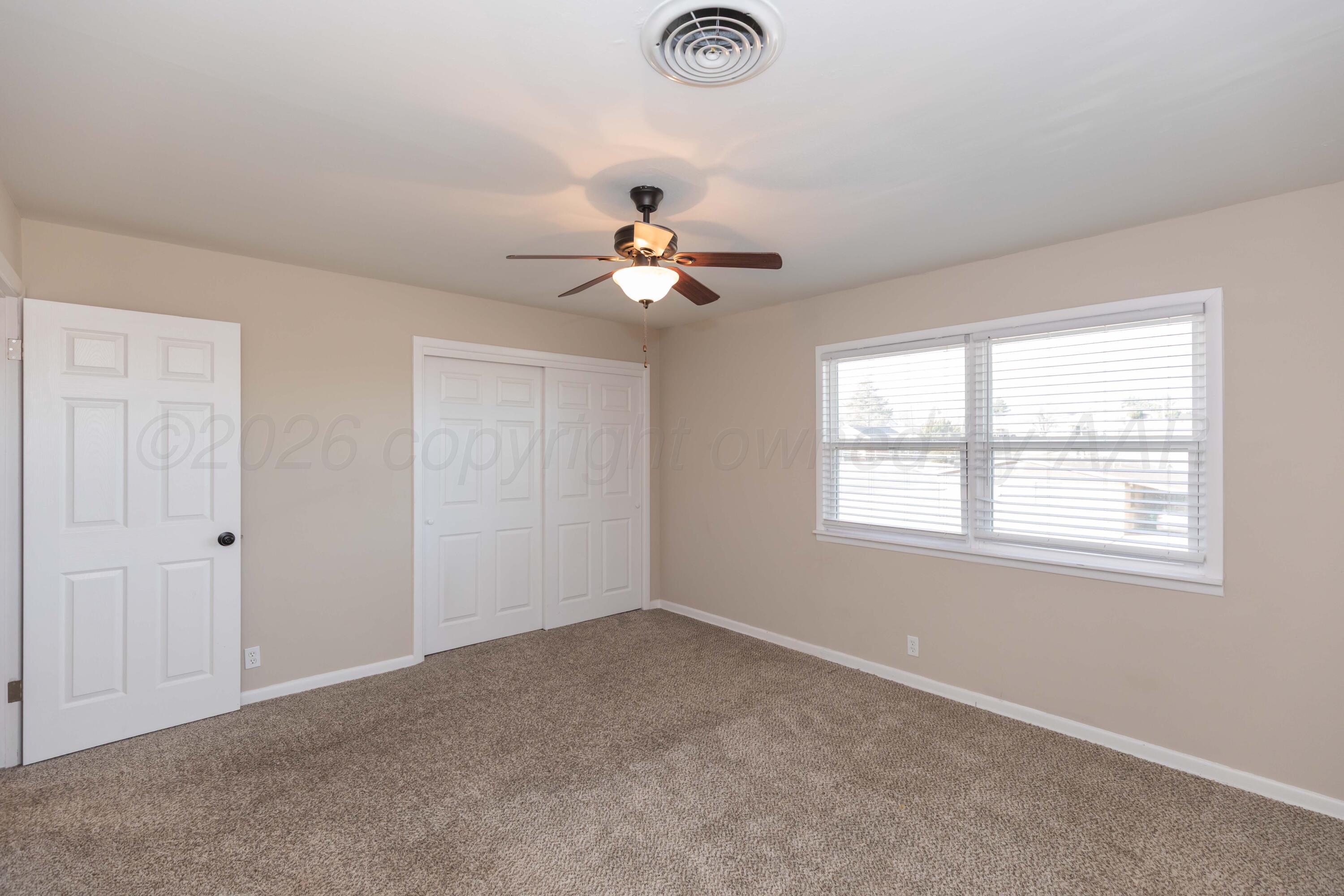 105 Smith Street Borger, TX 79007 - Photo 15 of 26 a view of a room with a ceiling fan and a window
